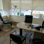 Dental chair next to a desk with chairs