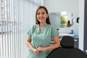 A happy, smiling oral surgery assistant