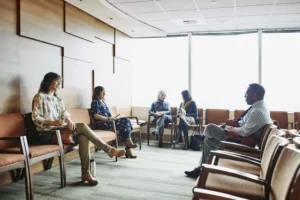 Patients sitting in chairs in a waiting room