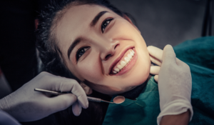 woman smiling after receiving all on 4 dental implants.