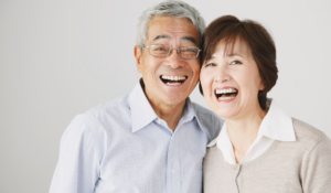 senior citizen couple smiling.
