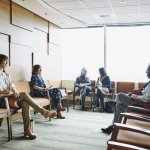 Patients sitting in chairs in a waiting room