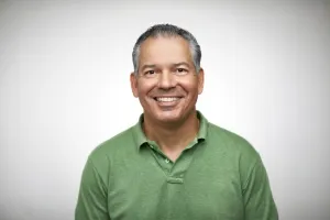 Smiling man in green shirt